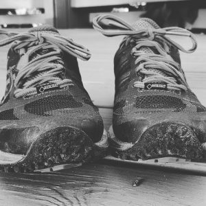 Black and white photo of trail running shoes.