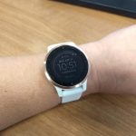 Photo of white Garmin Vivoactive 4s smart watch on woman's wrist.